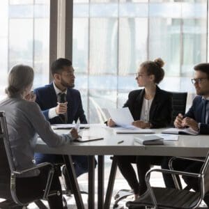 Business team meeting around table.